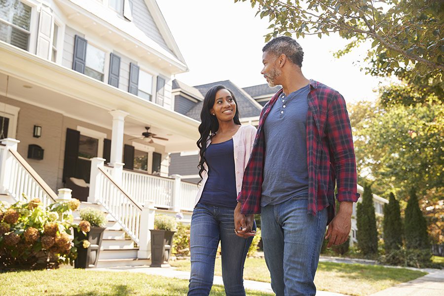 About Our Agency - Couple Holding Hands And Walking Down Street In Quiet Neighborhood